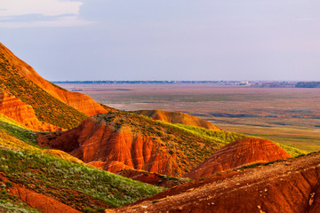 Big Bogdo mountain. Red sandstone outcrops on the slopes sacred mountain in Caspian steppe Bogdo -...