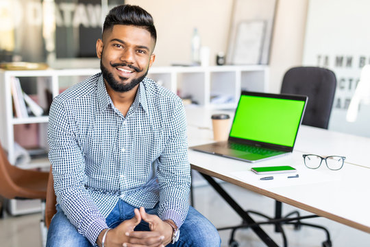 Young Indian Business Man Working On Laptop In Modern Office