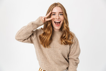 Attractive young girl wearing sweater standing isolated