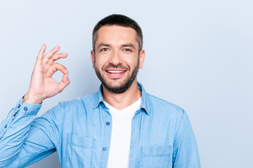 Close up photo amazing he him his guy macho perfect white teeth hands arms raised okey symbol advising buy buyer new tested product wear casual jeans denim shirt isolated grey background