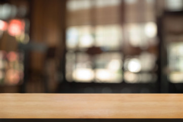 empty wood table with blur montage restaurant background