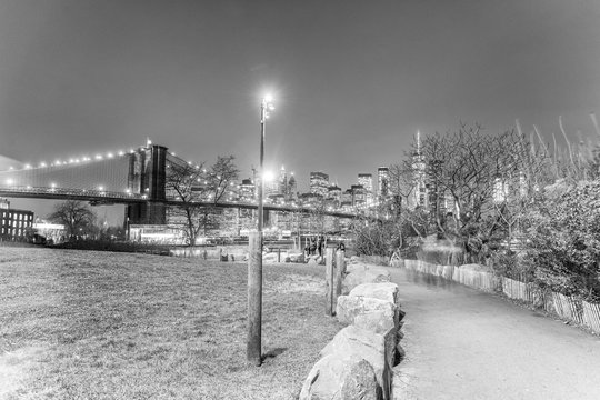 New York City. The Brooklyn Bridge at night, view from Main Street Park in Brooklyn