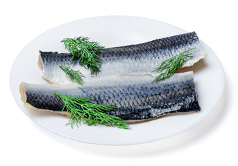 Two pieces of fresh appetizing Atlantic herring on a white plate decorated with dill. White isolated background.