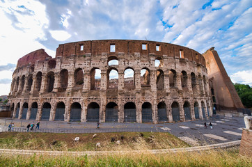 Fototapeta na wymiar ROME, ITALY - JUNE 2014: Tourists visit Colosseum. The city attracts 15 million people annually