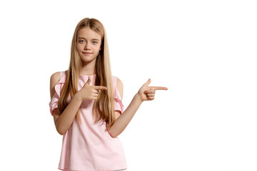 Studio portrait of a beautiful girl blonde teenager in a pink t-shirt posing isolated on white background.