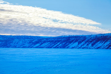 winter scenery with snowy hills and frozen lake 