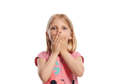 Close-up portrait of a nice blonde little kid in a pink t-shirt posing isolated on white background.