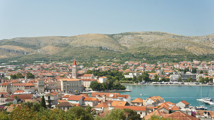 Naklejka na ściany i meble Scenic top view of the city with mountain background, beautiful cityscape, sunny day, Trogir, Dalmatia, Croatia