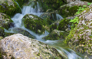 Water runs over rocks in the mountains
