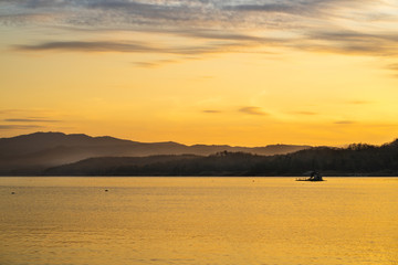 Wide-angle lake in the morning, sunrise after the mountain
