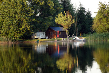 Obraz premium Blick auf gemütliche Bungalows am Ufer eines See in Polen