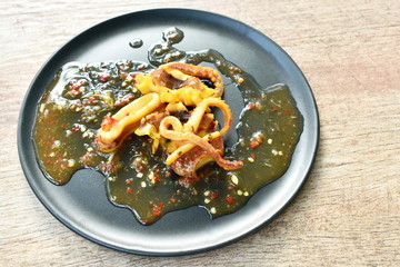grilled squid dressing spicy sauce on plate