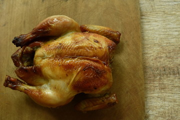 grilled chicken with sweet sauce on wooden chop block in home kitchen