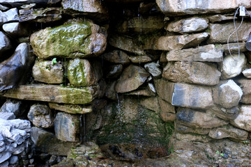 Beautiful fountain of stones in the forest