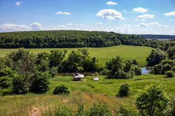 Panoramic view of the green valley of the river Protva from the village Ryabushki, Borovsk city, Kaluzhskiy region, Russia. June 2019