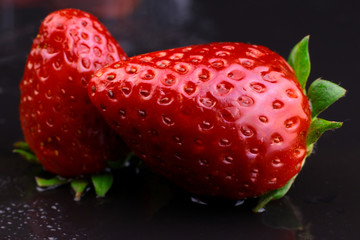 Strawberries.  Fresh juicy strawberries with water drops on dark background.