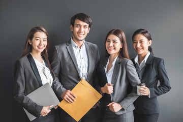 Portrait group of Asian business people in formal suit over black background