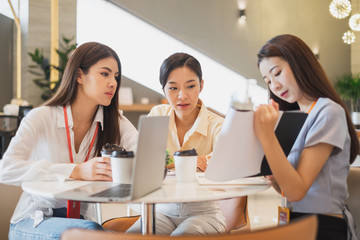 Group of Asian businesswomen working and discussing at office