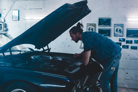 Attractive Caucasian Man Carrying Out Maintenance Of His Old Vintage Retro Car