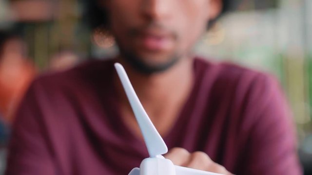 Model of wind turbine in man's hands