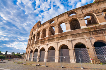 Fototapeta premium ROME, ITALY - JUNE 2014: Tourists visit Colosseum. The city attracts 15 million people annually