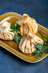 Khinkali, Georgian dumplings, traditional Georgian cuisine. Khinkali on a plate side view.