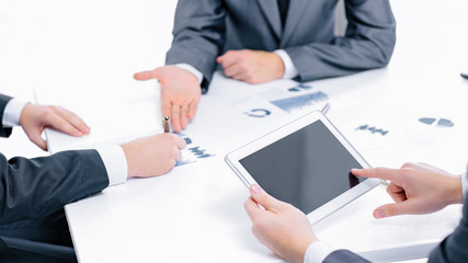 close up.the businessman uses a digital tablet to find partners