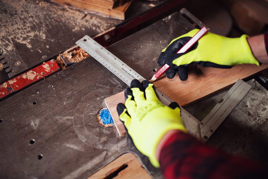 Hands of carpenter working in workshop