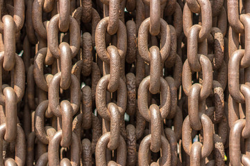 Iron chain. Chain links. Rusty background. Strong and strong connection. Heavy item. The texture of iron closeup. Grunge style. Industrial theme.