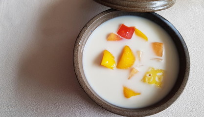 Coconut dessert in a brown clay plate. 