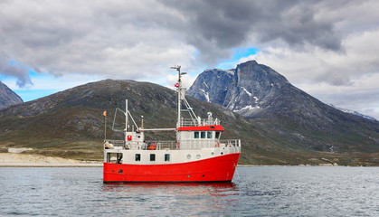 Boat and landscapes of Greenland, Nuuk fjord, ocean with mountains background
