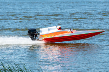 Speed boat go fast along the lake