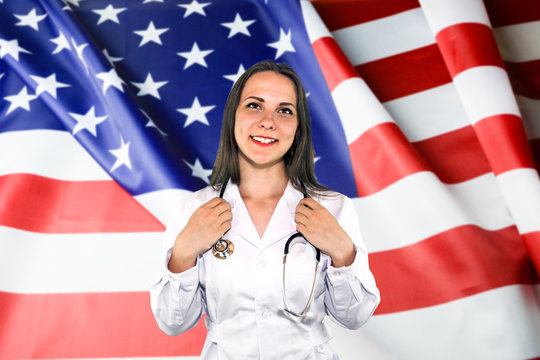 Mid section of a female doctor with stethoscope in hospital against composite image of digitally generated united states national flag