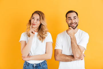 Image of thoughtful couple man and woman dreaming and thinking while looking upward together