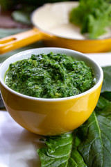 Healthy vegetarian or vegan food, cooked green spinach with cream, ingredient for many dishes like pasta, ravioli or soup