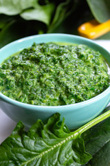Healthy vegetarian or vegan food, cooked green spinach with cream, ingredient for many dishes like pasta, ravioli or soup