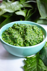 Healthy vegetarian or vegan food, cooked green spinach with cream, ingredient for many dishes like pasta, ravioli or soup