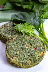 Healthy vegetarian or vegan food, uncooked green spinach burgers, ingredient for hamburgers