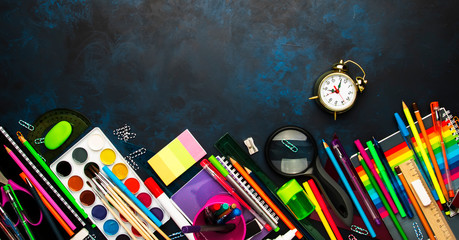 Back to school background with space for text, notebooks, pens, pencils, other stationery on blue chalk board desk, education concept, flat lay, top view