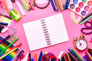 Back to school background with space for text, notebooks, pens, pencils, other stationery on pink modern background, education concept, flat lay, top view