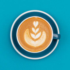 Cappuccino cup on blue background