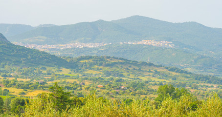 Scenic landscape of green hills and rocky mountains of the island of Sardinia in spring