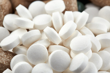 Fototapeta na wymiar Close-up photo of small white pills. Medicine