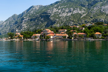 Fototapeta na wymiar Fragment of the Bay of Kotor with houses on shore, Montenegro