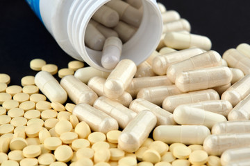 Close-up photo of many white and yellow pills
