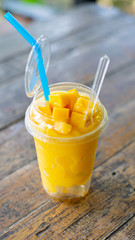 Smoothie mango juice on wooden table