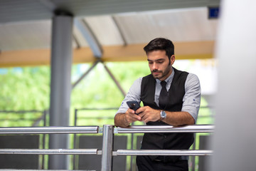 Portrait of smiling businessman with smartphone