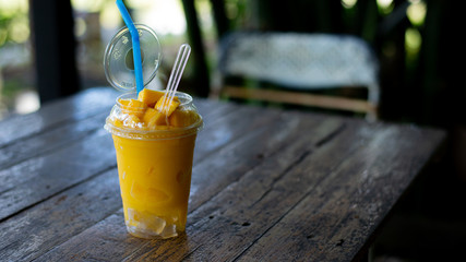 Smoothie mango juice on wooden table
