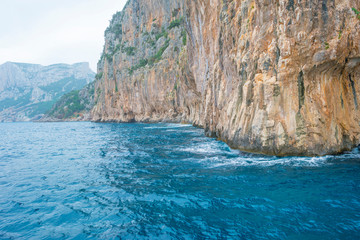 Fototapeta na wymiar Rocky coast of the island of Sardinia in the Mediterranean Sea viewed from a boat