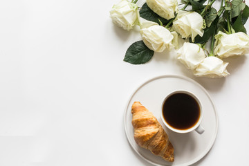 Cup of coffee and freshly baked croissants. Top view. Copy space.